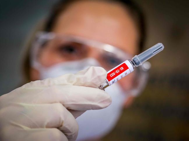 (FILES) In this file photo taken on August 08, 2020 A nurse shows a COVID-19 vaccine produced by Chinese company Sinovac Biotech at the Sao Lucas Hospital, in Porto Alegre, southern Brazil. - Brazil's health regulator said on November 9, 2020 it had suspended clinical trials of a Chinese-developed Covid-19 vaccine after an "adverse incident" involving a volunteer recipient, a blow for one of the most advanced vaccine candidates. (Photo by SILVIO AVILA / AFP)