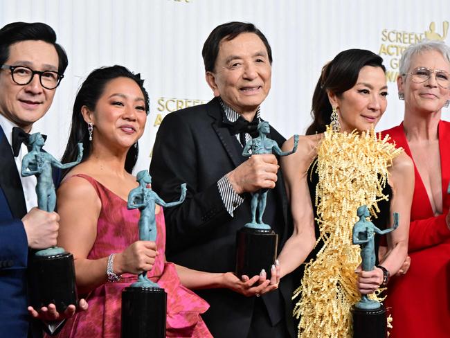 (FILES) In this file photo taken on February 26, 2023 actors Michelle Yeoh, Ke Huy Quan, Stephanie Hsu, Jamie Lee Curtis and James Hong pose with the award for Outstanding Performance by a Cast in a Motion Picture for "Everything Everywhere All at Once" during the 29th Screen Actors Guild Awards at the Fairmont Century Plaza in Century City, California. - The Oscars take place March 12, 2023, with two big questions on everyone's lips: Will anyone get slapped? And can a wacky sci-fi featuring hot dog fingers and butt plugs really win best picture? (Photo by Frederic J. Brown / AFP)