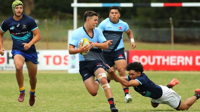 Joe Walsh of NSW is tackled in the match against the Barbarians.