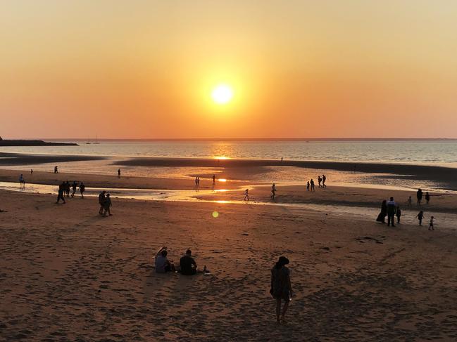 Beachgoers take a minute to watch the setting sun. Picture: Werner Kalin