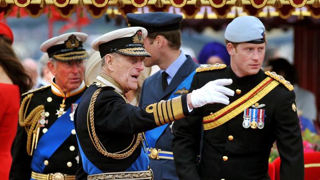 Prince Charles, Prince of Wales, Prince Philip, Duke of Edinburgh, Prince William and Prince Harry talk onboard the Spirit of Chartwell during the Thames Diamond Jubilee Pageant on the River Thames in London. Picture: AFP