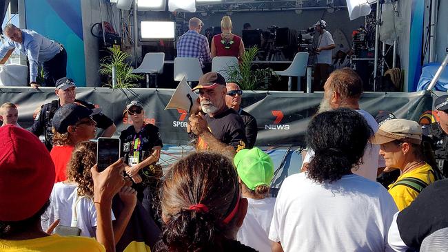 Indigenous protesters pictured disrupting a broadcast of the Seven Network's Sunrise program at Kurrawa Beach on the Gold Coast on Tuesday, April 10, 2018 (AAP Image/Ed Jackson)