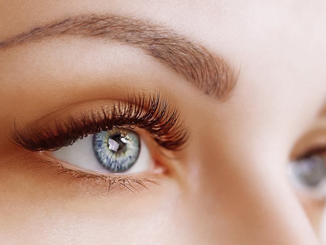 Eyelash Extension Procedure. Woman Eye with Long Eyelashes. Lashes. Close up, macro, selective focus