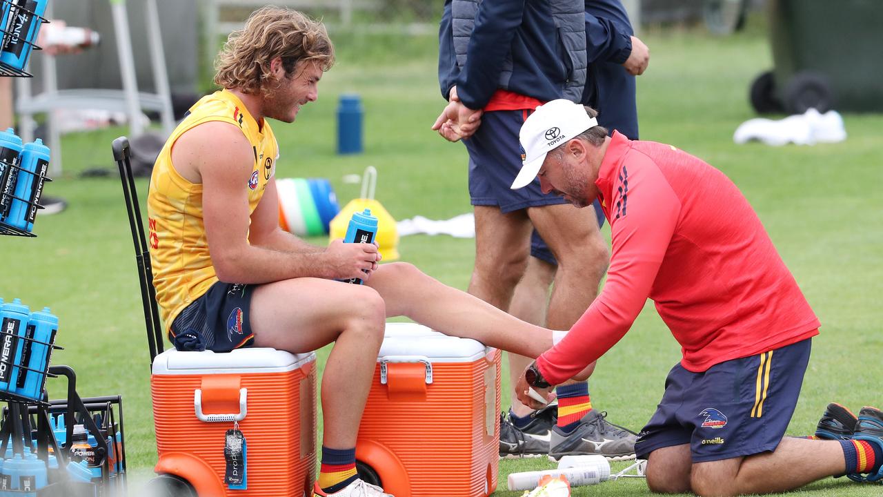 Luke Pedlar gets his ankle restrapped. Picture: Sarah Reed