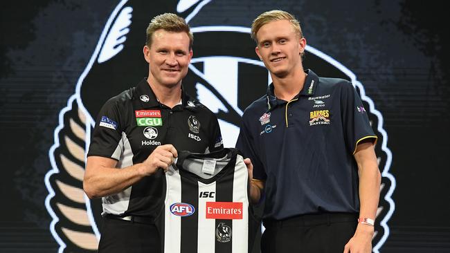 Jaidyn Stephenson is presented with his Collingwood jumper by Nathan Buckley at the draft. Picture: Getty Images