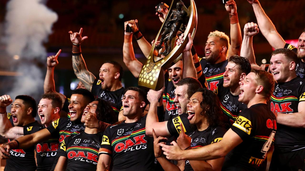 Panthers players celebrate with the NRL premiership trophy after victory in the grand final. Picture: Chris Hyde/Getty Images