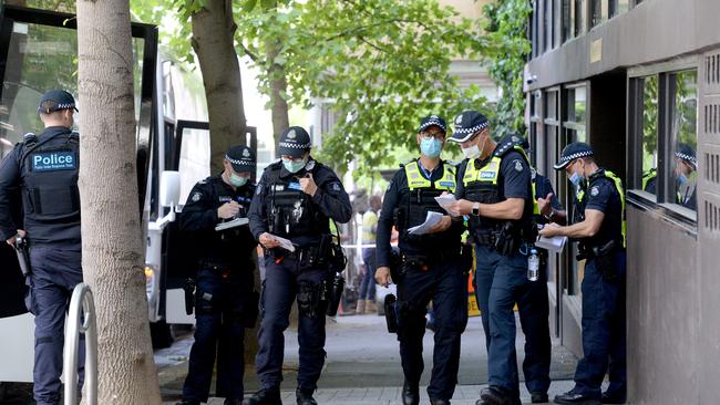 Police gather outside the Park Hotel in Carlton. Picture: Andrew Henshaw