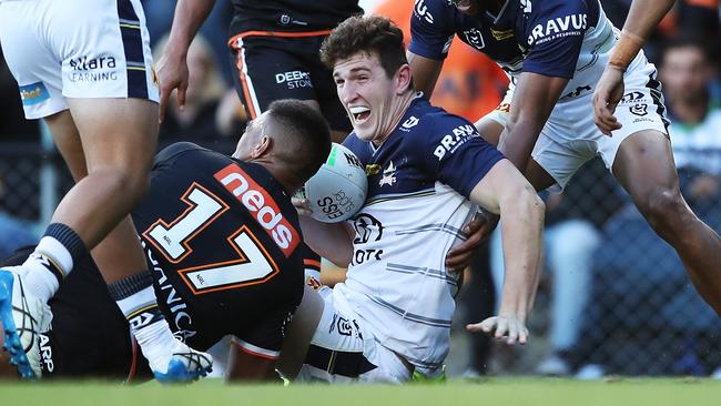 SYDNEY, AUSTRALIA - APRIL 11: Ben Condon of the Cowboys celebrates with team mates after scoring a try during the round five NRL match between the Wests Tigers and the North Queensland Cowboys at Leichhardt Oval, on April 11, 2021, in Sydney, Australia. (Photo by Matt King/Getty Images)