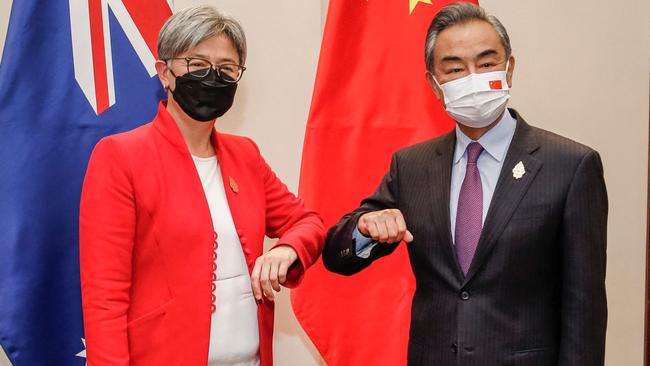 Australia's Foreign Minister Penny Wong bumps elbows with China's Foreign Minister Wang Yi. Picture: AFP