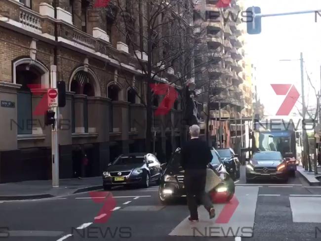 Another shot of the bystander holding his chair. Picture: Seven News