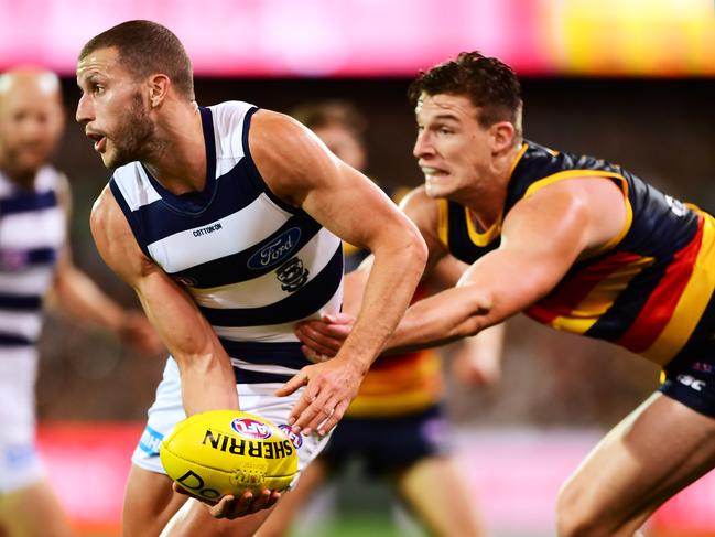 Josh Jenkins tackles Geelong’s Sam Menegola during round three between the Adelaide Crows and the Geelong Cats at Adelaide Oval. Picture: Mark Brake/Getty Images