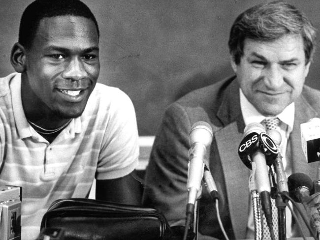 FILE - in this May 5, 1984 file photo, North Carolina guard Michael Jordan, left, and Tar Heels coach Dean Smith are shown at a news conference in Chapel Hill, N.C., where Jordan announced he would forfeit his final year of college eligibility to turn pro. Smith, the North Carolina basketball coaching great who won two national championships, died "peacefully" at his home Saturday night, Feb. 7, 2015, the school said in a statement Sunday from Smith's family. He was 83. (AP Photo, File)