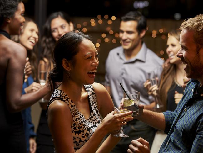 Couples Dancing And Drinking At Evening Party