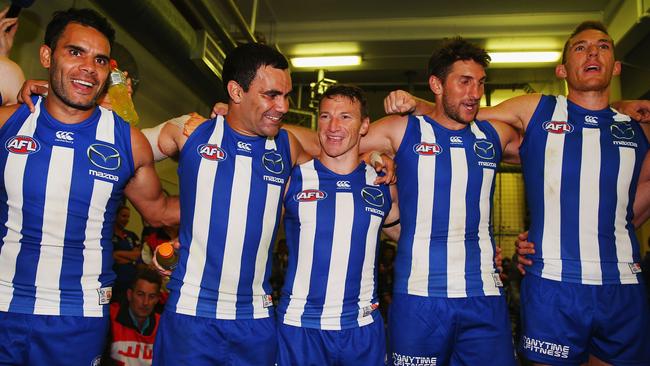 (From left) Daniel Wells, Lindsay Thomas, Brent Harvey, Jarrad Waite and Drew Petrie sing the song after a win.