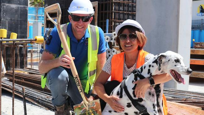 Condev project manager Andy Baxter with developer Michiy Tanabe and her dog getting their hand and paw prints into the cement.