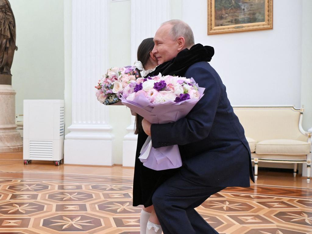 Putin hugs a child on TV as his missiles kill them
