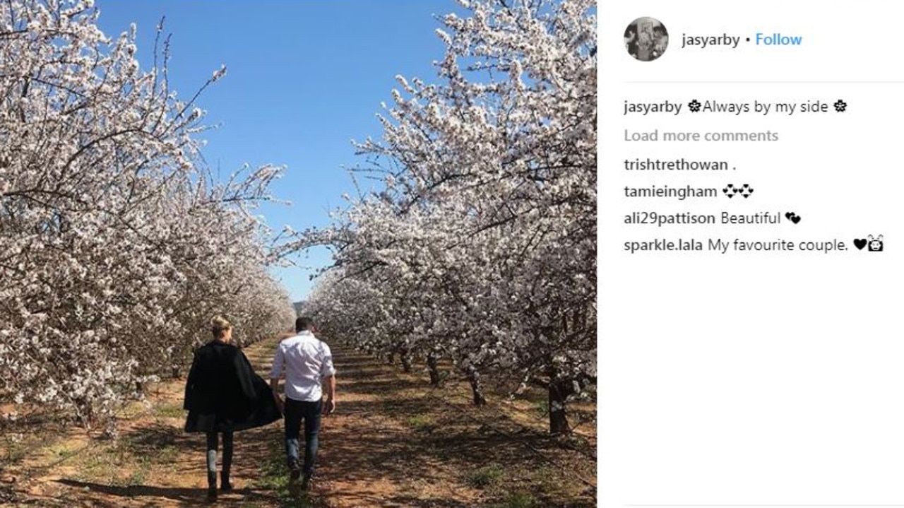 Instagram post by Jasmine of her and Karl in an almond orchard, saying ‘always by my side’.