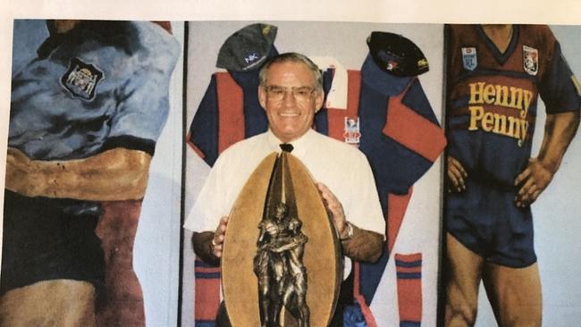 Mr Maughan holding the 1997 Knights premiership trophy. Supplied.