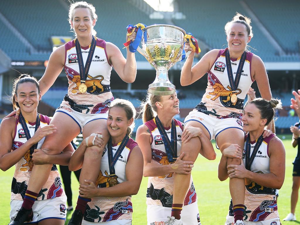 Lauren Arnel (left) and teammate Emma Zielke are chaired off Adelaide Oval after winning the 2021 AFLW grand final. Picture: Mark Brake/Getty Images