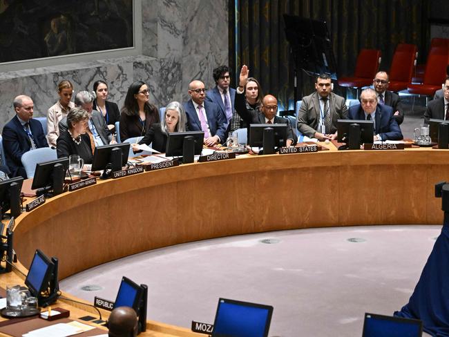 US Alternate Ambassador to the United Nations Robert Wood raises his hand to veto a draft resolution calling for a ceasefire in Gaza, during the United Nations Security Council meeting on Wednesday. Picture: AFP.