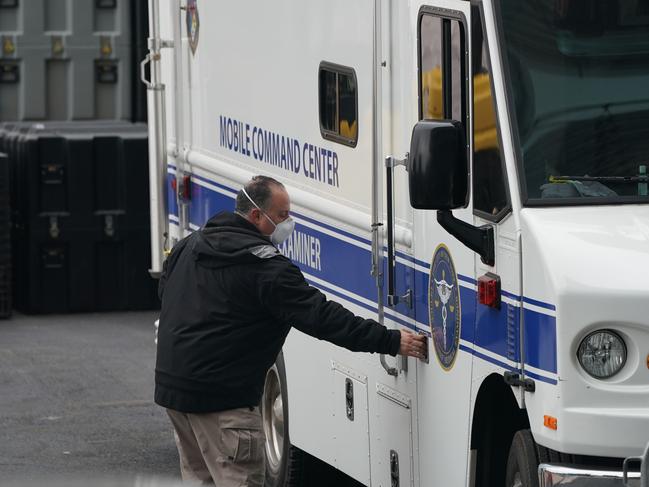 A member of the NYC Medical Examiner's Office at the site as workers build a makeshift morgue outside of a Manhattan hospital. Picture: AFP