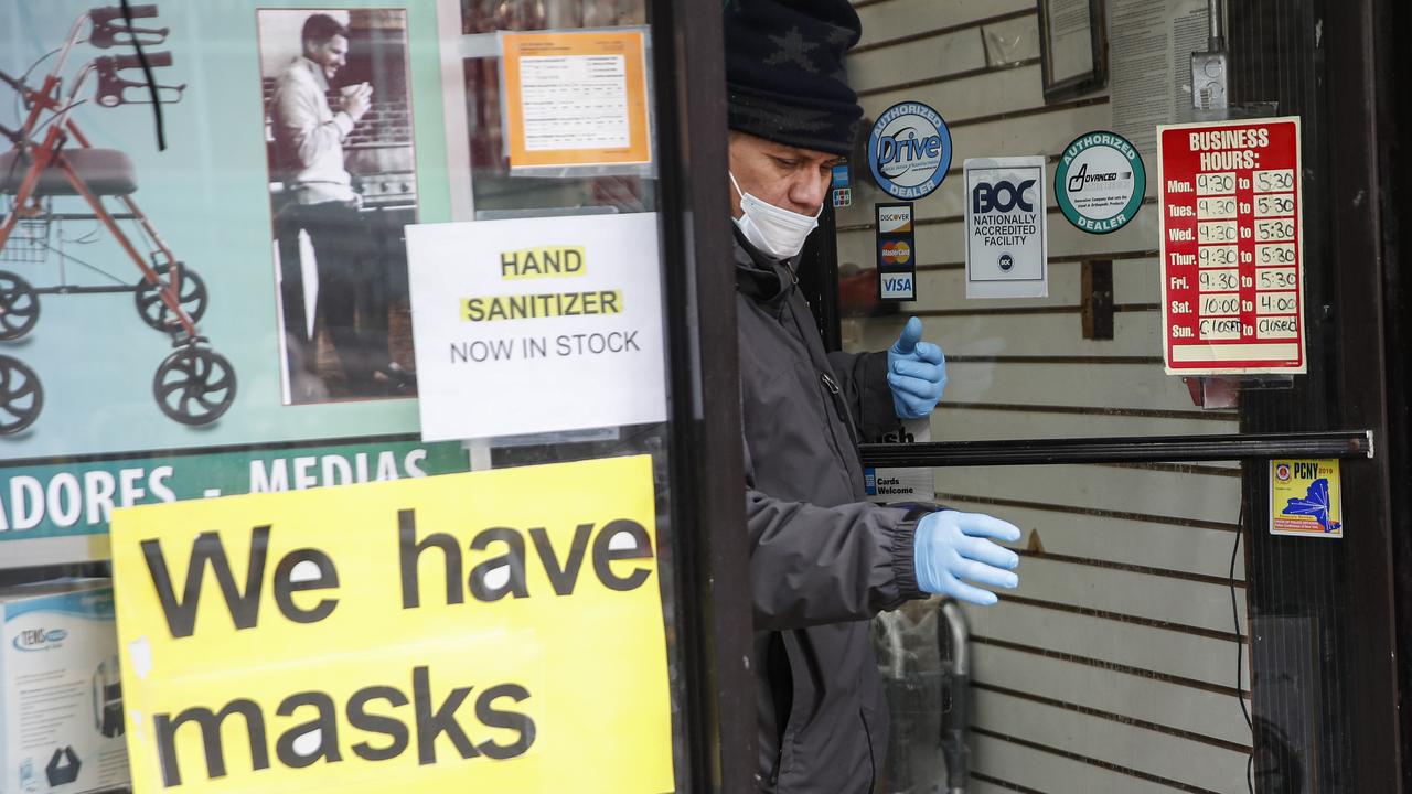 A customer leaves a shop advertising personal protective equipment in New York on March 25. Picture: John Minchillo/AP