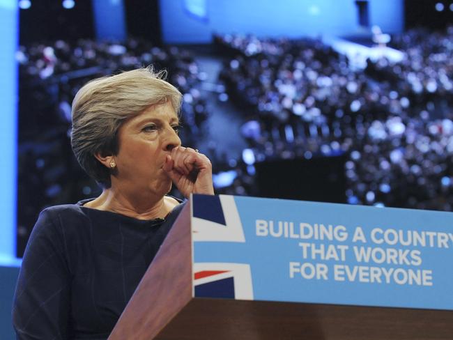 Prime Minister Theresa May coughs during her address to delegates at the Conservative Party Conference. Picture: AP Photo/Rui Vieira