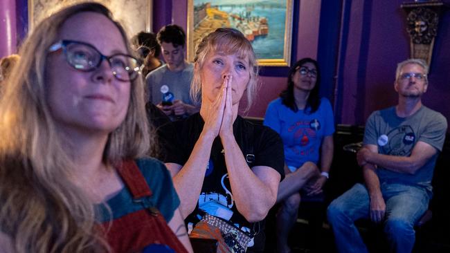 Viewers in Cincinnati wear buttons showing support for the Biden-Harris campaign. Picture: AP/WSJ