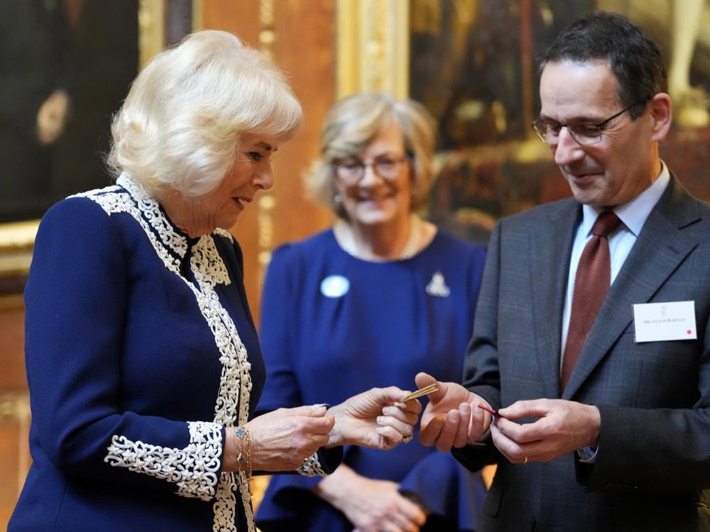 Queen Camilla is given a miniature book by Glenn Bartley, head of the Royal Bindery during a reception at Windsor Castle. Picture: Getty Images