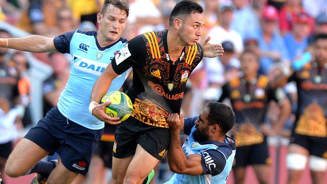 Shaun Stevenson of the Chiefs looks to unload under pressure from the Waratahs defence at the Global Tens tournament on Saturday.