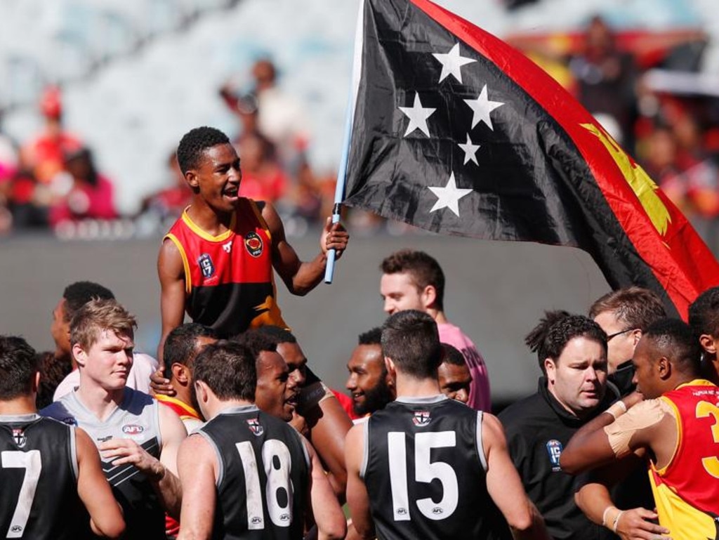 Oea with the PNG flag after the 2017 AFL International Cup Grand Final against New Zealand. Picture: Michael Dodge/Getty Images