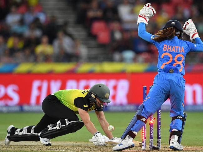 Ellyse Perry of Australia is bowled for a duck by Poonam Yadav of India as wicketkeeper Taniya Bhatia reacts during the WT20 World Cup cricket match between Australia and India at Sydney Showground Stadium in Sydney, Friday, February 21, 2020. (AAP Image/Dean Lewins) NO ARCHIVING, EDITORIAL USE ONLY, IMAGES TO BE USED FOR NEWS REPORTING PURPOSES ONLY, NO COMMERCIAL USE WHATSOEVER, NO USE IN BOOKS WITHOUT PRIOR WRITTEN CONSENT FROM AAP