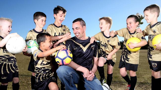 Coach of The Ponds Sharks under 6's Shane Caffyn with players Kai Mead, Declan Galea, Samuel Macri, William Caffyn, Liam Knight, Taylor Stevens and Michael Hoult at Jonas Bradley Park. Pictures: Justin Sanson