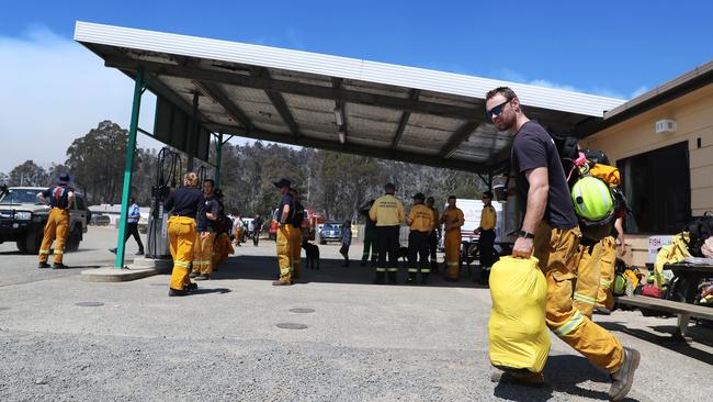 Personnel from the ACT Rural Fire Service head out from The Great Lakes store to the fire front near Miena. Picture: LUKE BOWDEN