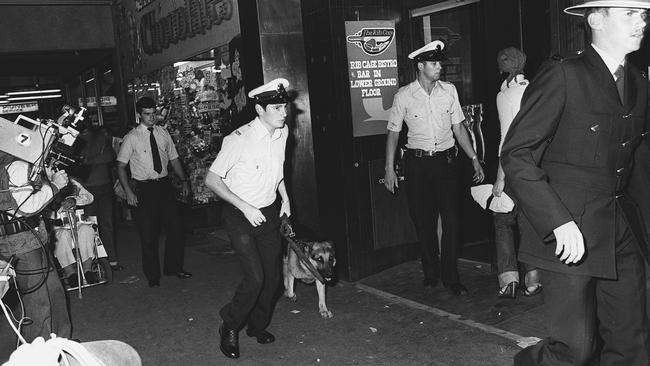 Police and dogs on the scene of the fatal armed robbery at the Manchester Unity Building in March 1978.