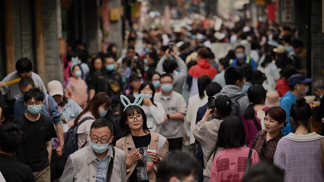 People walk through an alley near Houhai lake in Beijing. Picture: AFP