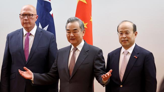 Peter Dutton with Chinese Foreign Minister Wang Yi, centre, and Mr Xiao. Picture: AFP