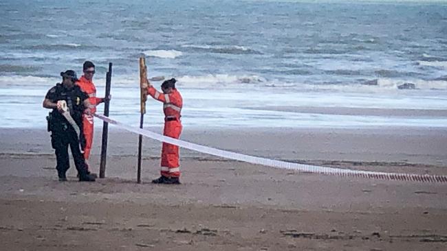 Police and other emergency services personnel on Casuarina Beach where a man’s body was discovered this morning. Picture: Glenn Campbell