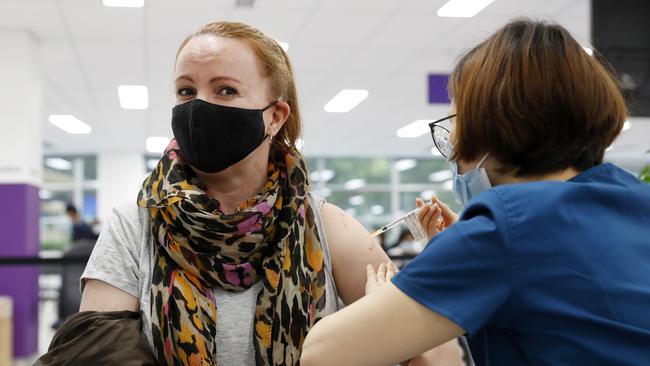 Nurse Samantha Kim giving Beth Geddes from Redfern her COVID-19 vaccination at the Sydney Olympic Park NSW Health vaccination centre. Picture: Jonathan Ng