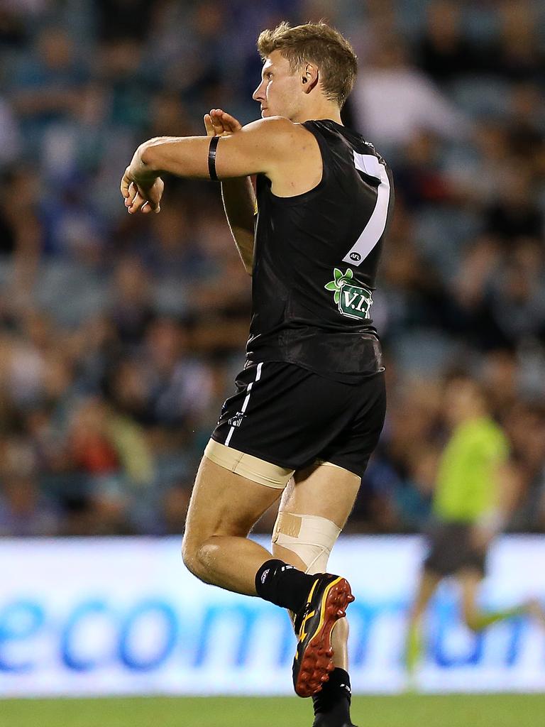 Brad Ebert touches his black arm band in tribute to McCarthy in 2013.