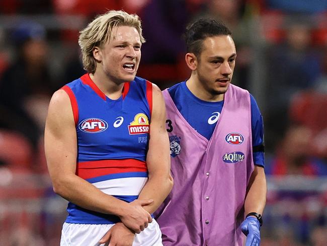 SYDNEY, AUSTRALIA - JUNE 18: Cody Weightman of the Bulldogs receives attention during the round 14 AFL match between the Greater Western Sydney Giants and the Western Bulldogs at GIANTS Stadium on June 18, 2022 in Sydney, Australia. (Photo by Cameron Spencer/Getty Images)