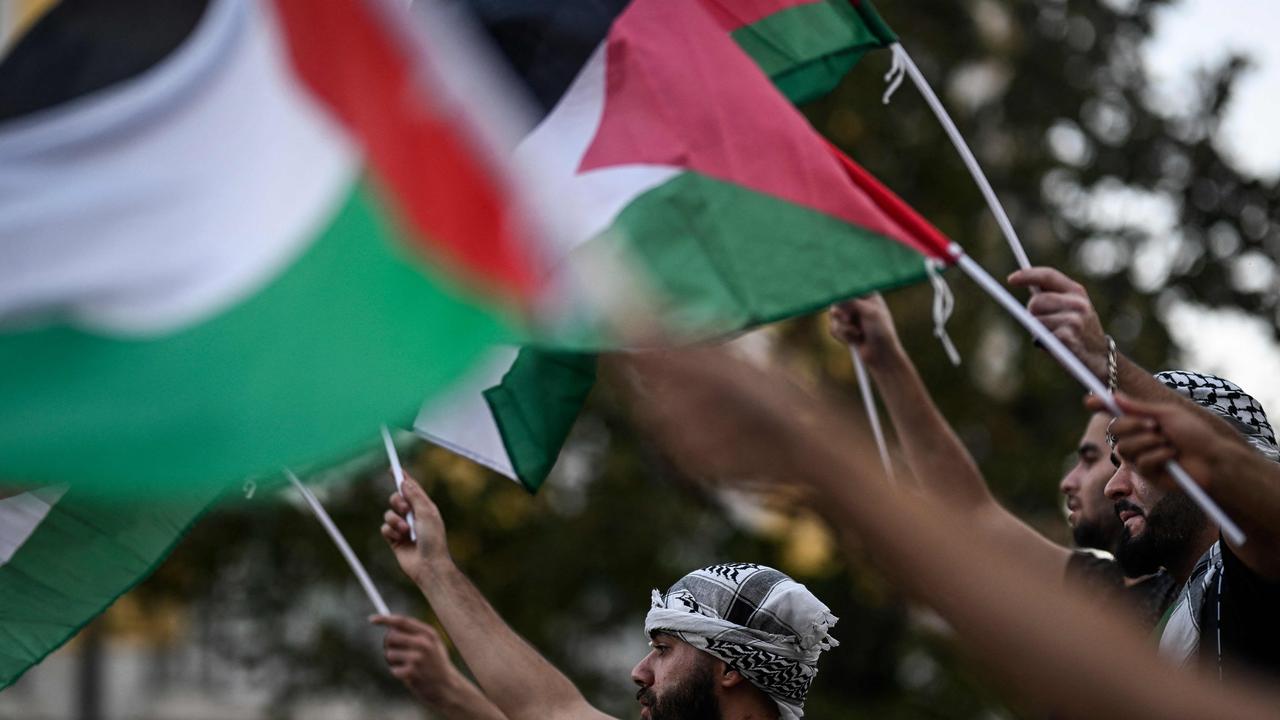 Protesters wave flags during a rally in support of Palestinians in Lisbon. Picture: AFP