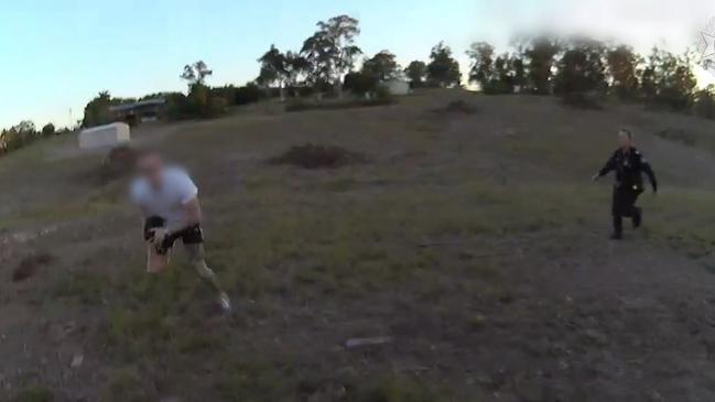 The footage shows the man trip over in a paddock, allowing police to surround him.