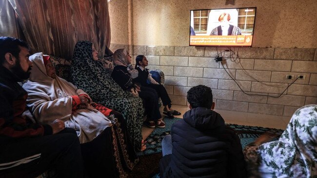 A Palestinian family in the southern Gaza Strip watched a TV broadcast Friday about the International Court of Justice’s initial decision in a case accusing Israel of genocide. Picture: AFP/Getty Images