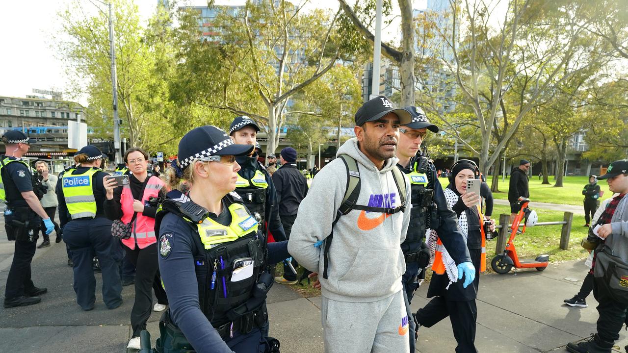 Police move on a protester outside the Land Forces event in Melbourne, rallying against the military expo and voicing concerns over Australia's involvement in the global arms trade. Picture: NewsWire / Luis Enrique Ascui