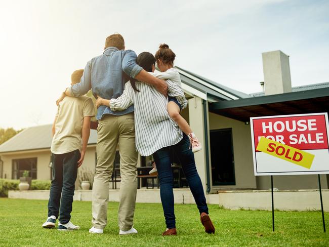 generic; couple in front of house for sale; house sold; real estate; hugging; iSTOCK