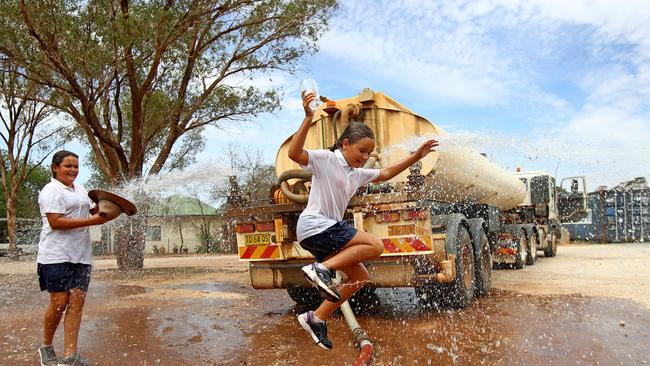 Locals make the most of the water delivery to Tottenham bowling club. Picture: Toby Zerna