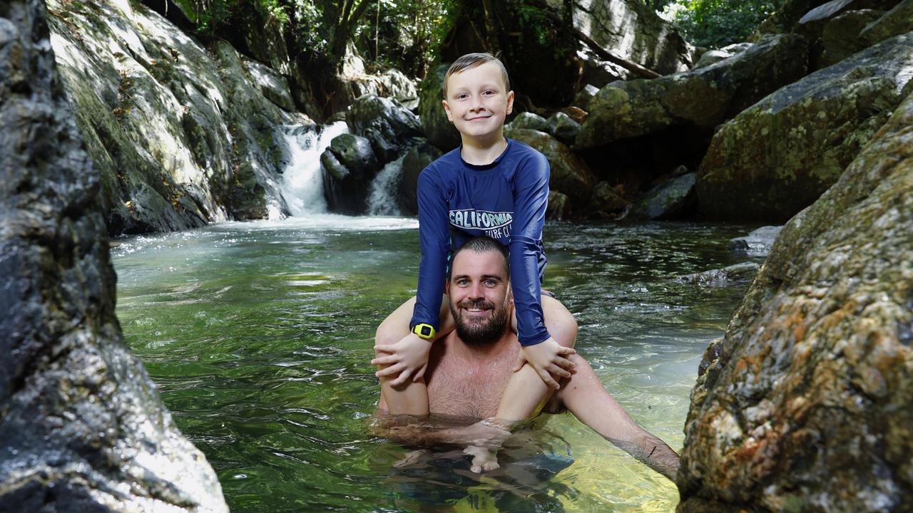 As the long, hot summer weather continues unabated in Far North Queensland, Cairns locals have been seeking shady water holes to find some reprieve from the warm temperatures and sticky humidity. Kai Gross and his uncle Brock Bish cool off from the summer heat by enjoying a swim in the cool waters of Stoney Creek in Kamerunga. Picture: Brendan Radke