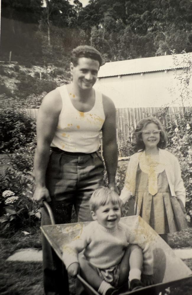 Peter Bevilacqua, as a young dad, pushing his son David in a wheelbarrow with his daughter Robyn looking on.