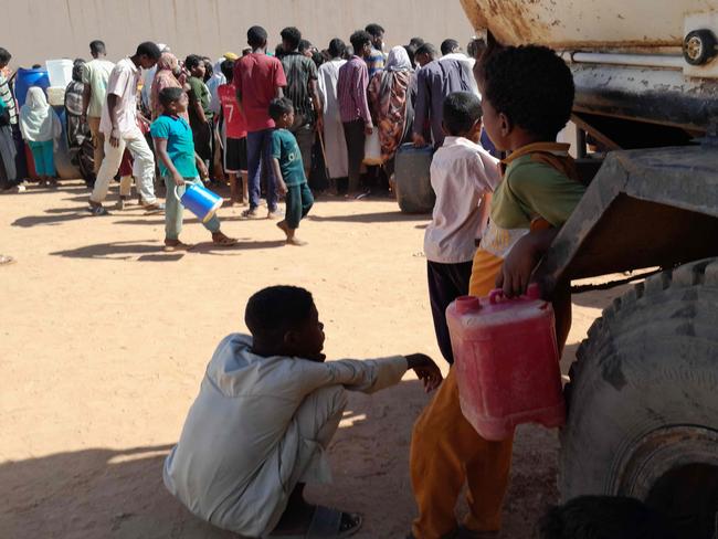 People queue for water in Omdurman, the Sudanese capital's twin city, on January 17, 2025. Picture” AFP